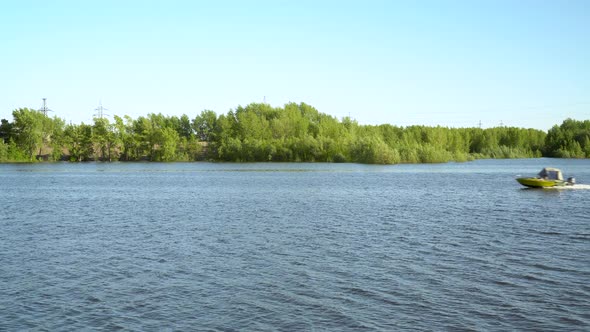 A Motor Boat Floats on a Blue River. Water Transport Moves Quickly.