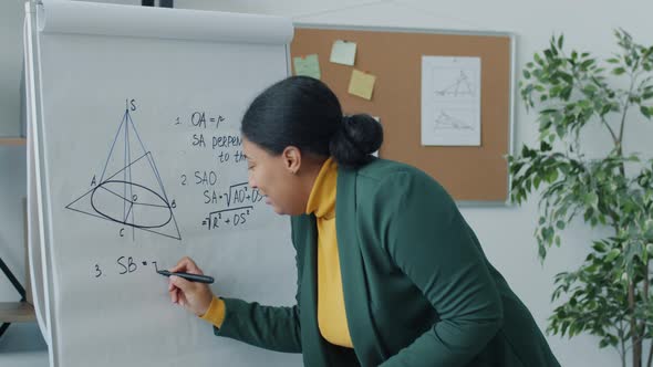 College Teacher Giving Online Lecture During Covid19 Pandemic Writing on Board Speaking Looking at alt