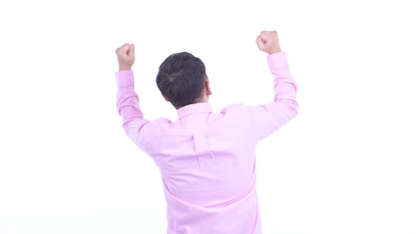 Rear View of Happy Japanese Businessman with Fists Raised