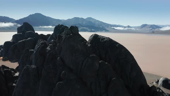 Cinematic Close Up Flight Above Scenic Black Stones in Death Valley Desert, 