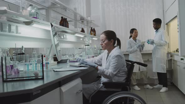 Female Scientist in Wheelchair Working in Lab