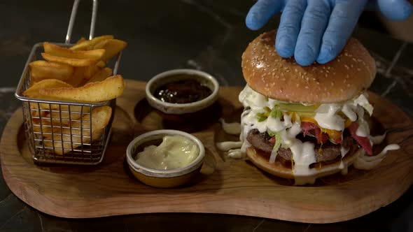 Chef Hands Making Gourmet Hamburger.