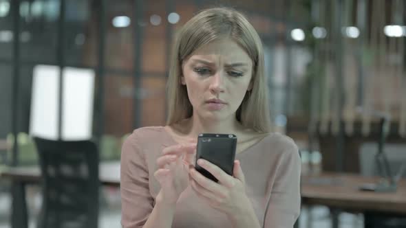 Portrait Shoot of Young Woman Getting Upset on Cellphone