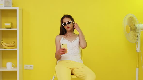 Woman Is Sitting Near Electric Fan and Making Selfie