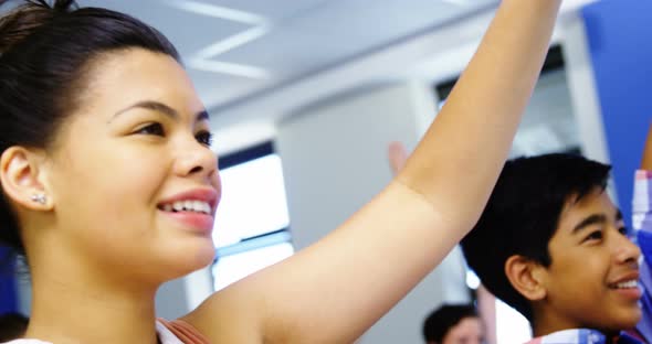 Student raising hand in classroom