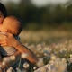 Slow Motion of a Young Happy Mother and Child in a Flower Field at Sunset. - VideoHive Item for Sale