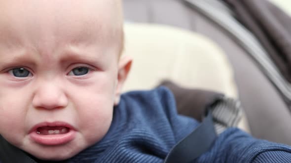 Crying Baby Infant Portrait Opened Mouth Teeth Outdoors in Carriage Fussy Kid