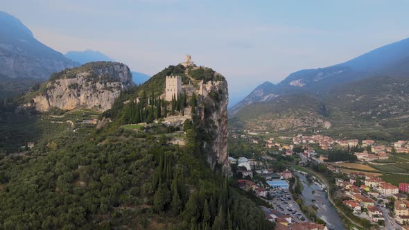 Castello di Arco, castle on steep cliff above Reva Del Garda city Trentino Italy . Aerial view of la