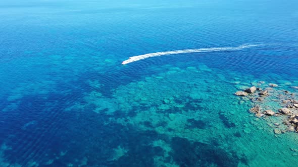 Aerial View of a Motor Boat Towing a Tube. Zakynthos, Greece