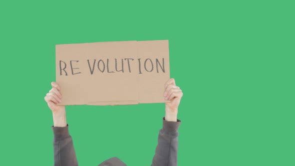 Protester Hands Holding Cardboard Banner with Revolution Inscription on Green Chromakey Background