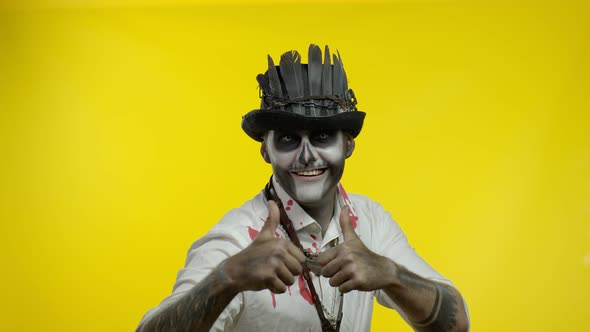 Frightening Man in Skeleton Halloween Cosplay Makeup Looking at Camera, Showning Thumbs Up Gesture