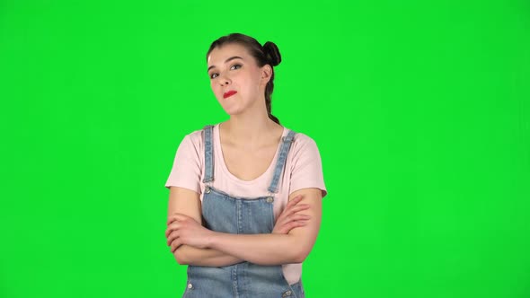 Girl Coquettishly Smiling While Looking at Camera on Green Screen