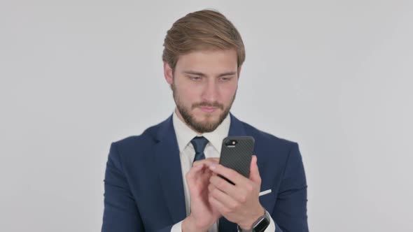 Young Businessman Browsing Smartphone on White Background