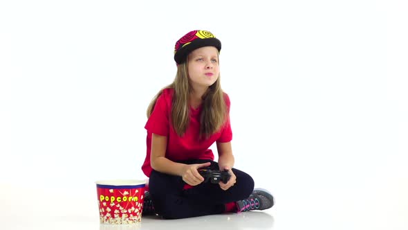 Teen Eats Popcorn, Plays Joystick in Online Game. Slow Motion alt