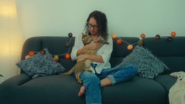 Woman Resting on a Sofa with a Cat