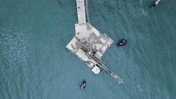 Historic coal mining platform located out in the ocean waters. Highing drone view