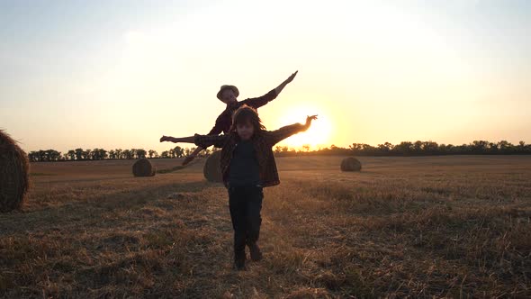 Happy Father and Son Playing Airplanes in Nature