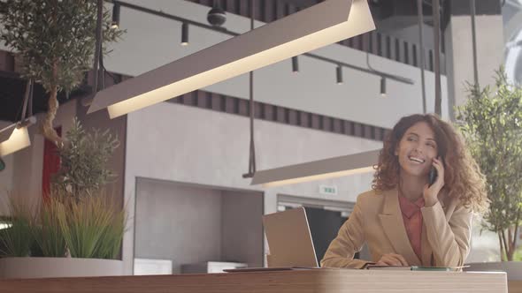 Smiling Elegant Woman Chatting on Smartphone