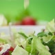 Fresh salad falling into bowl on green background - VideoHive Item for Sale