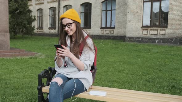 Girl Using Smart Phone While Charging on the Power Bank