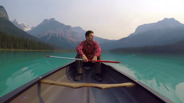 Man sitting on boat in lake