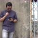 Asian men stand using mobile phones - VideoHive Item for Sale