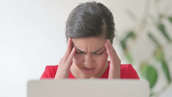 Close Up of Indian Woman Having Headache While Working on Laptop