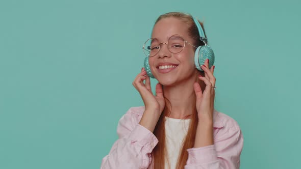 Happy Pretty Relaxed Girl Listening Music on Headphones and Dancing Disco Fooling Around Having Fun