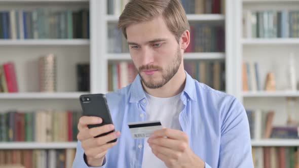 Portrait of Man Making Online Payment on Smartphone