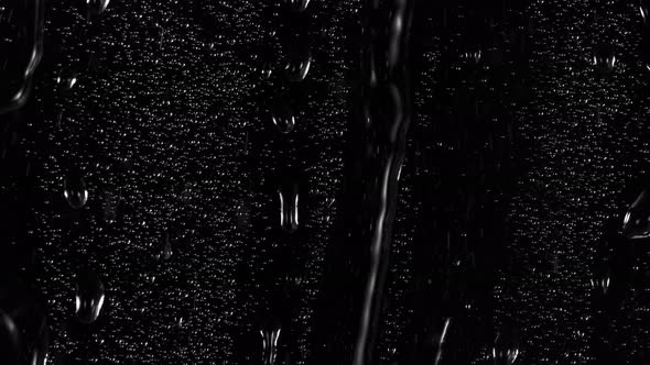 Super Slow Motion Shot of Water Drops Flowing on Transparent Glass at 1000 Fps