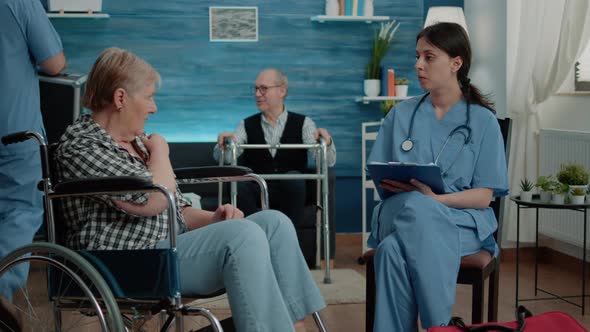 Retired Woman with Handicap Talking to Nurse for Medical Checkup