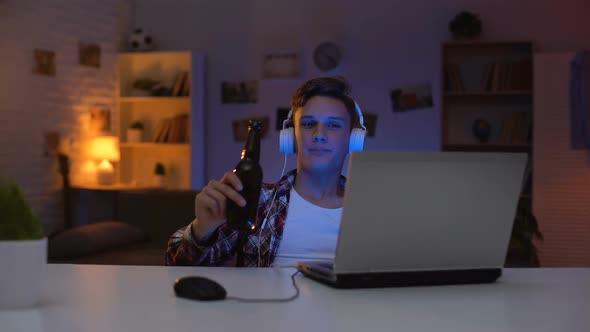 Teen Boy Watching Movie on Laptop, Drinking Beer, Eating Snacks, Wasting Time