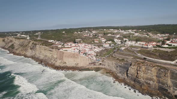 Small majestic town of Azenhas Do Mar on ocean cliffside, aerial drone view