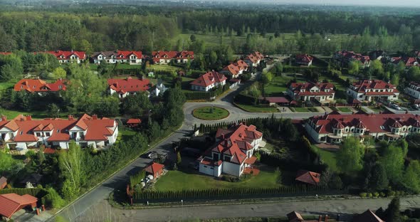 Drone flight in left direction over a new housing estate in the suburbs.