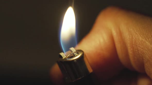 Close Up Slow Motion Shot of Lighter on the Man Hand