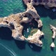 Drone shot of kayaks and boats passing in the ocean, people exploring caves and tunnels. - VideoHive Item for Sale