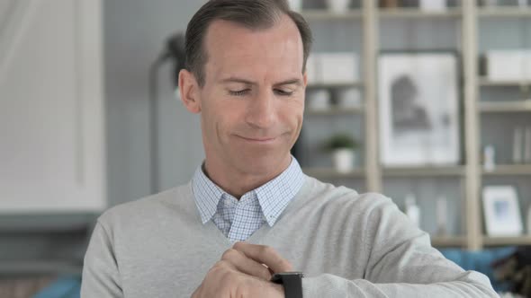 Middle Aged Man Using Smartwatch