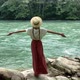 Young beautiful vintage woman in straw boater hat raising hands up near mountain river travel nature - VideoHive Item for Sale