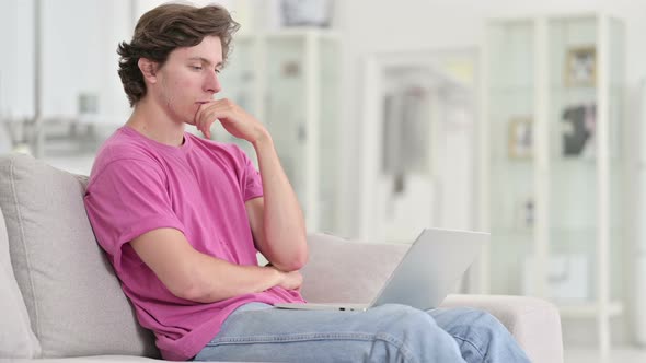 Casual Young Man Using Laptop at Home 