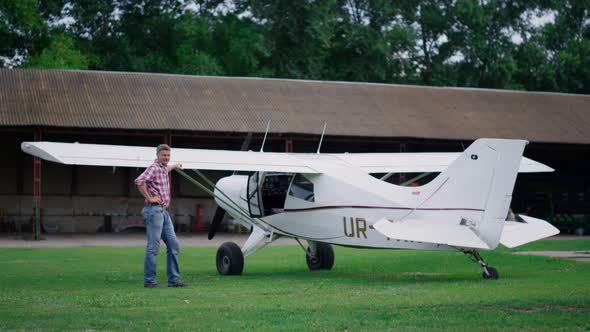 Pilot Posing Standing Airplane on Airfield