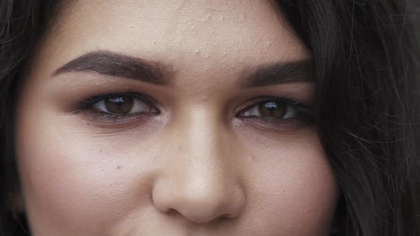 Macro Look Into Camera of Browneyed Brunette with Makeup