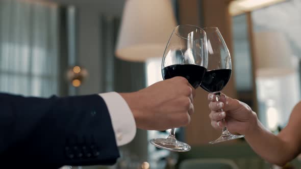 Romantic feast in the restaurant with glasses of red wine close-up