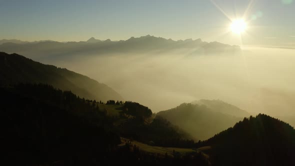 Flying high above mist layer at sunset in alpine environment. Near "Les Rochers de Naye", Switzerlan