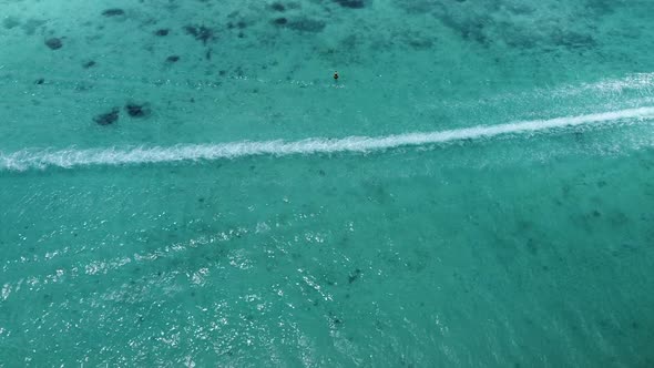 Static backwards aerial of speedboat driving on ocean,cinematic