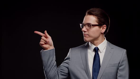 Studio portrait of successful and smart businessman in suit and tie.