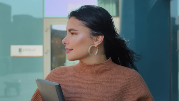 Closeup Young Attractive Female Professional Manager Going Down Street Against Backdrop of Office