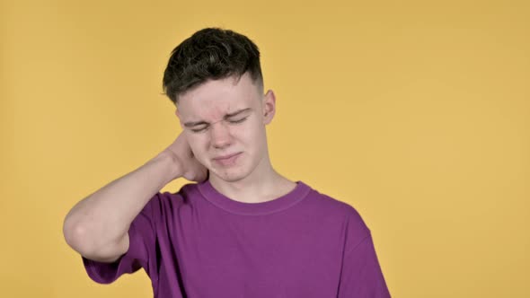 Young Man with Neck Pain, Yellow Background