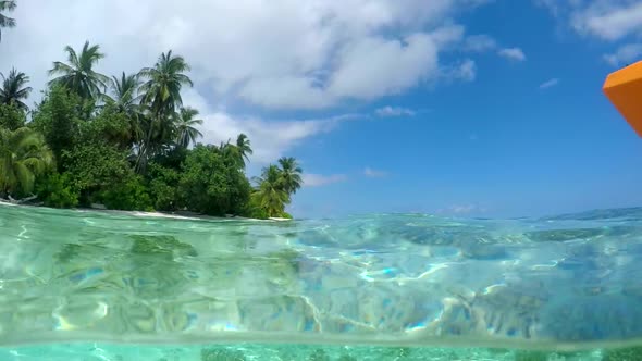 Water shot of a man kayaking around a tropical island.