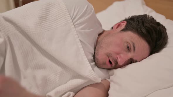 Middle Aged Man Waking up from Nightmare in Bed