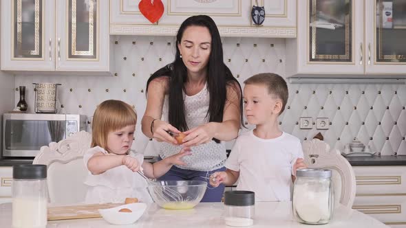 Cute Mother with Son and Daughter Learn Kneading Dough for Pie